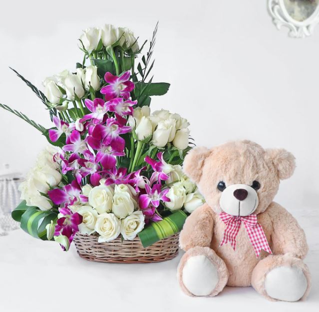 Fresh red rose bouquet paired with a cute plush teddy bear for online gift delivery in Hyderabad